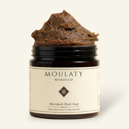 Marrakech Black Soap in a jar, herbal detox skincare with natural exfoliating texture.