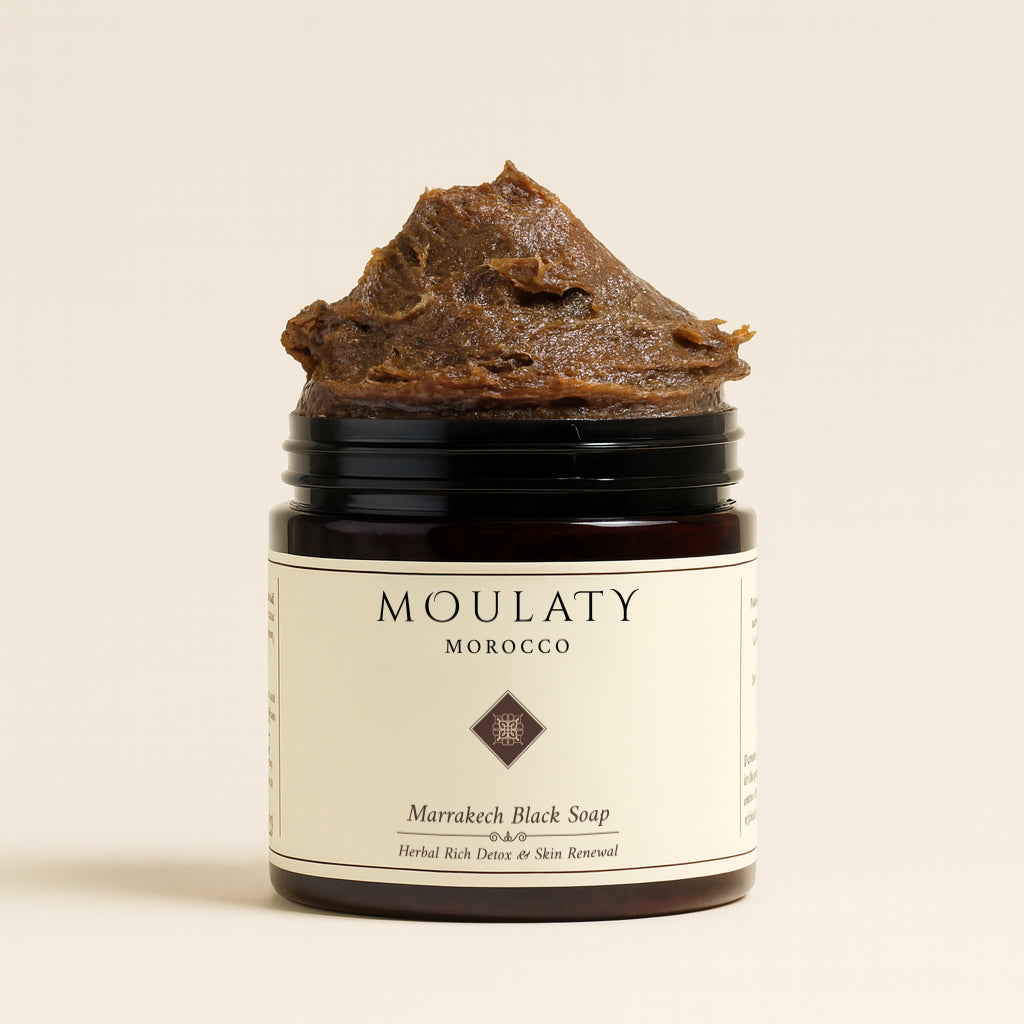 Jar of Marrakech black soap with herbal-rich textured paste for gentle exfoliation and detox.