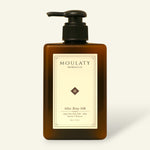 Amber pump bottle of Atlas Rosy Silk argan rose body milk against a beige background.