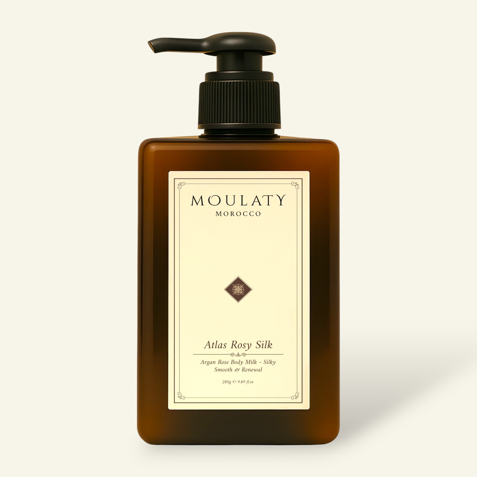 Amber pump bottle of Atlas Rosy Silk argan rose body milk against a beige background.