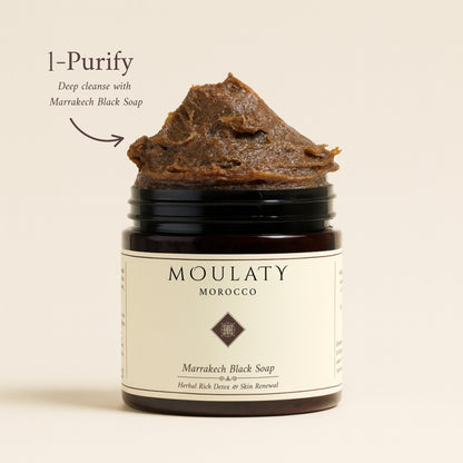 Jar of Marrakech Black Soap with herbal detox skincare label and natural paste texture.