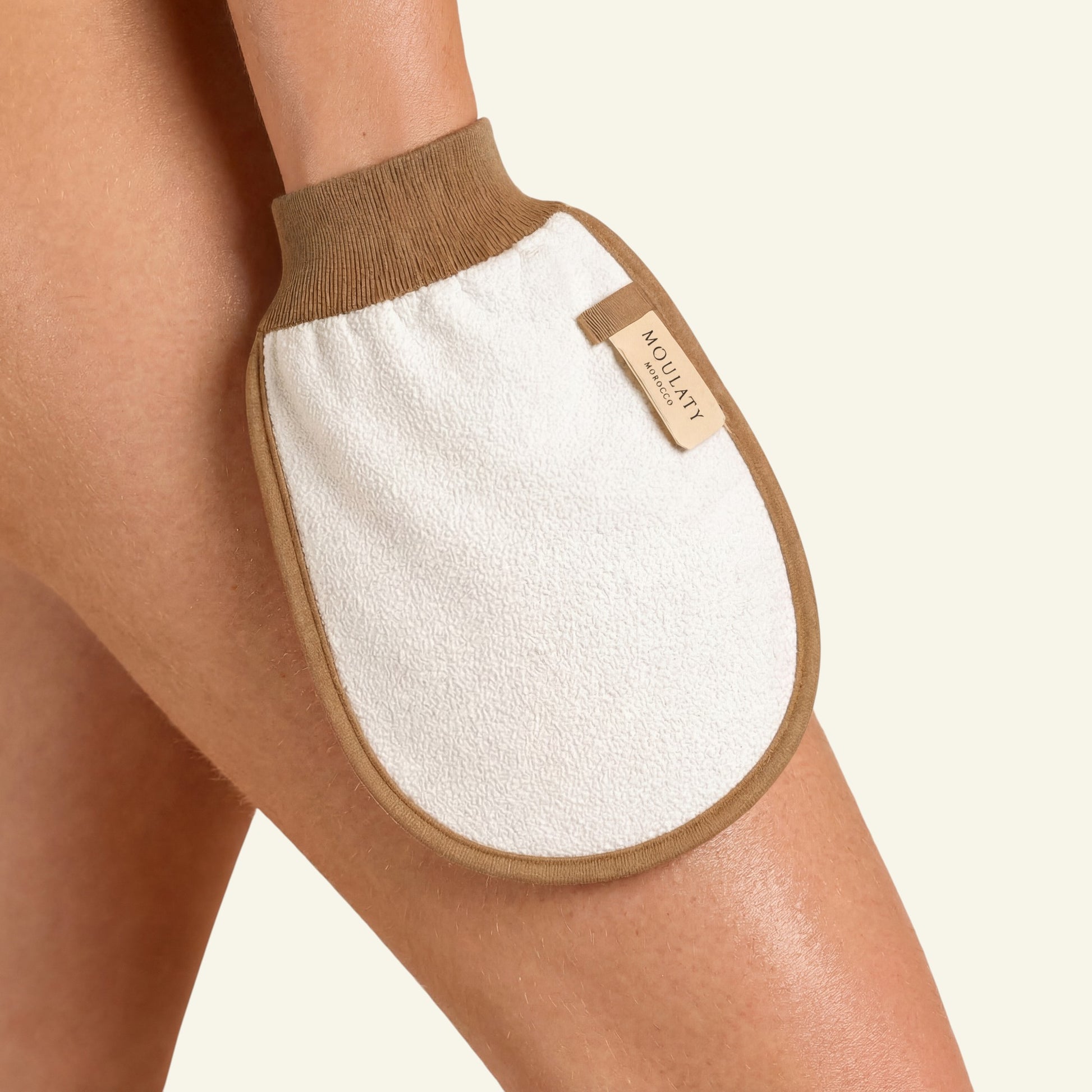 Moroccan exfoliating mitt glove on skin for hammam body scrub and gentle exfoliation