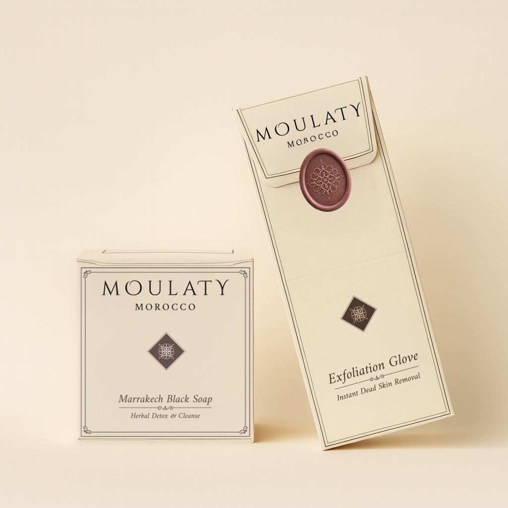 Moroccan black soap and exfoliating kessa glove duo in cream packaging on beige background